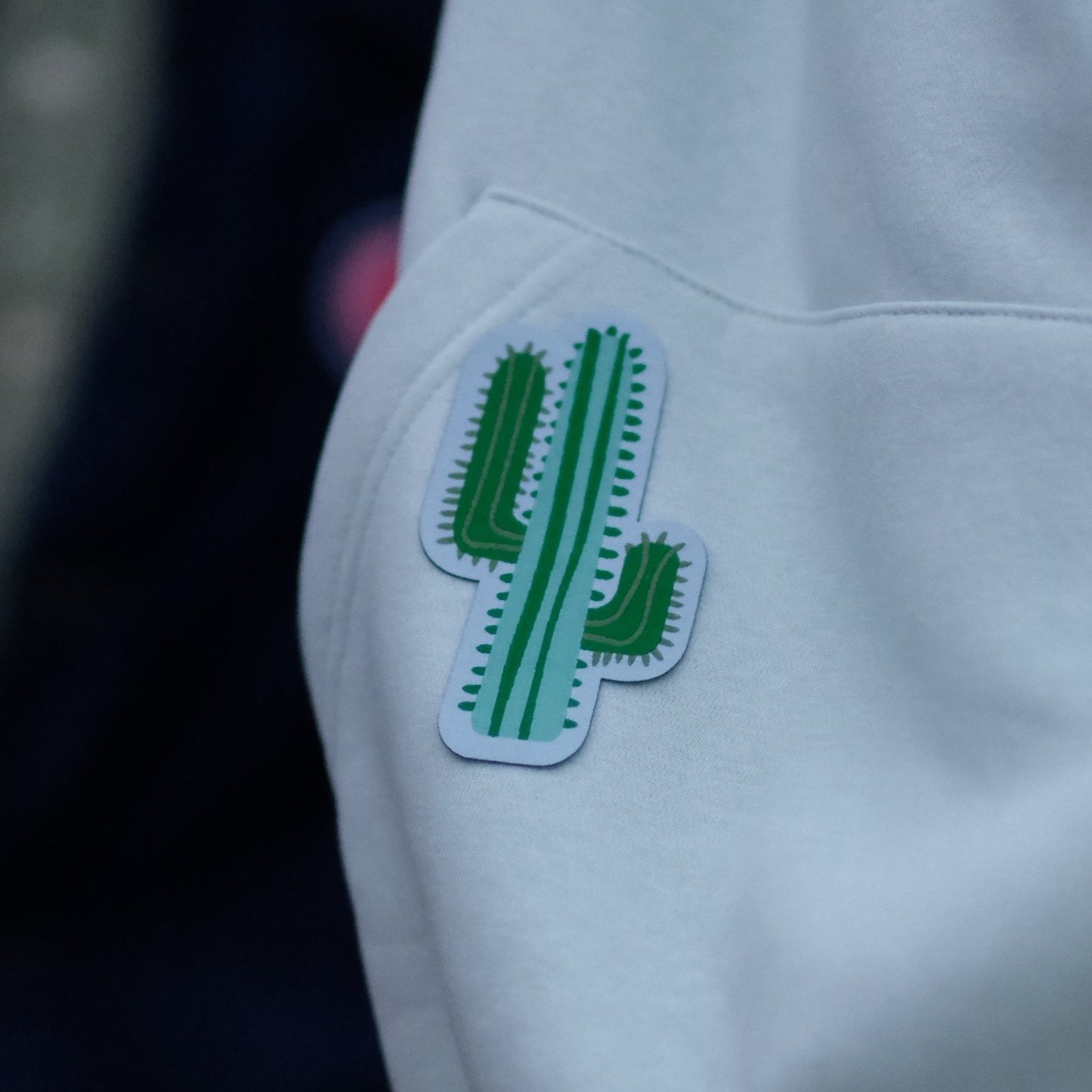Taggarna utåt mot onödig klädkonsumtion! Vår cactus på en vit hoodie.
